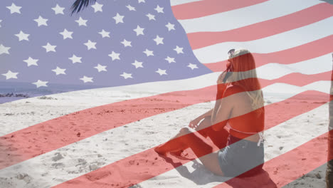 animación de la bandera estadounidense ondeando sobre la mujer hablando en el teléfono inteligente en la playa