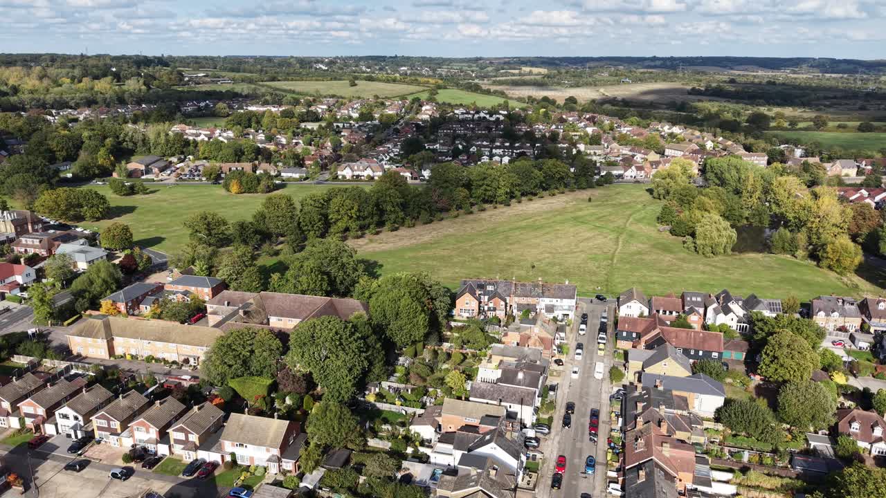 Panning drone aerial Theydon Bois village Essex UK village green