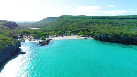 Drone-Se-Eleva-Sobre-Una-Aislada-Cala-De-Playa-Tropical-De-Arena-Blanca,-Curazao