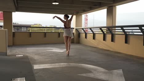 hermosa bailarina sola en un parkade de la ciudad