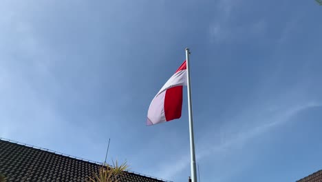 Indonesische-Flagge-Weht-Auf-Einem-Hohen-Mast-Vor-Einem-Wunderschönen-Blauen-Himmel-Im-Bürobereich