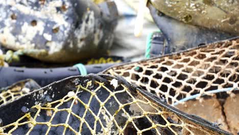 stacked empty fishing industry lobster net baskets closeup left dolly