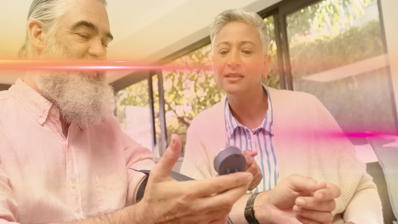 Man holding BP cuff while woman pressing monitor causing pink flare during health demo glass doors