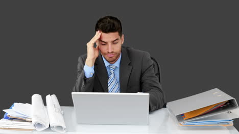 Young-businessman-working-at-his-desk