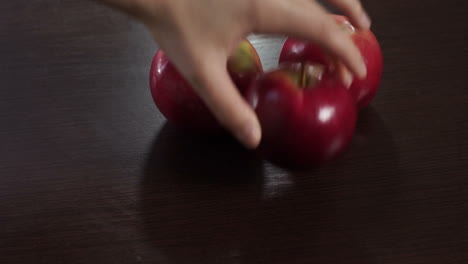 farmer put freshly harvested apples on wooden table. organic fresh fruits