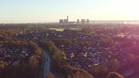 early morning sunrise fiddlers ferry power station skyline aerial view overlooking autumn coloured british suburban townhouse neighbourhood