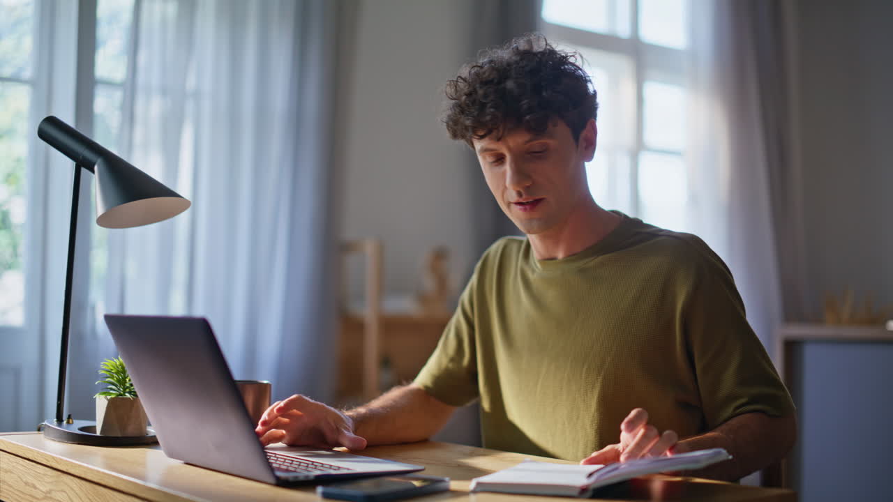 Remote worker looking laptop at home cabinet closeup. Young guy studying online