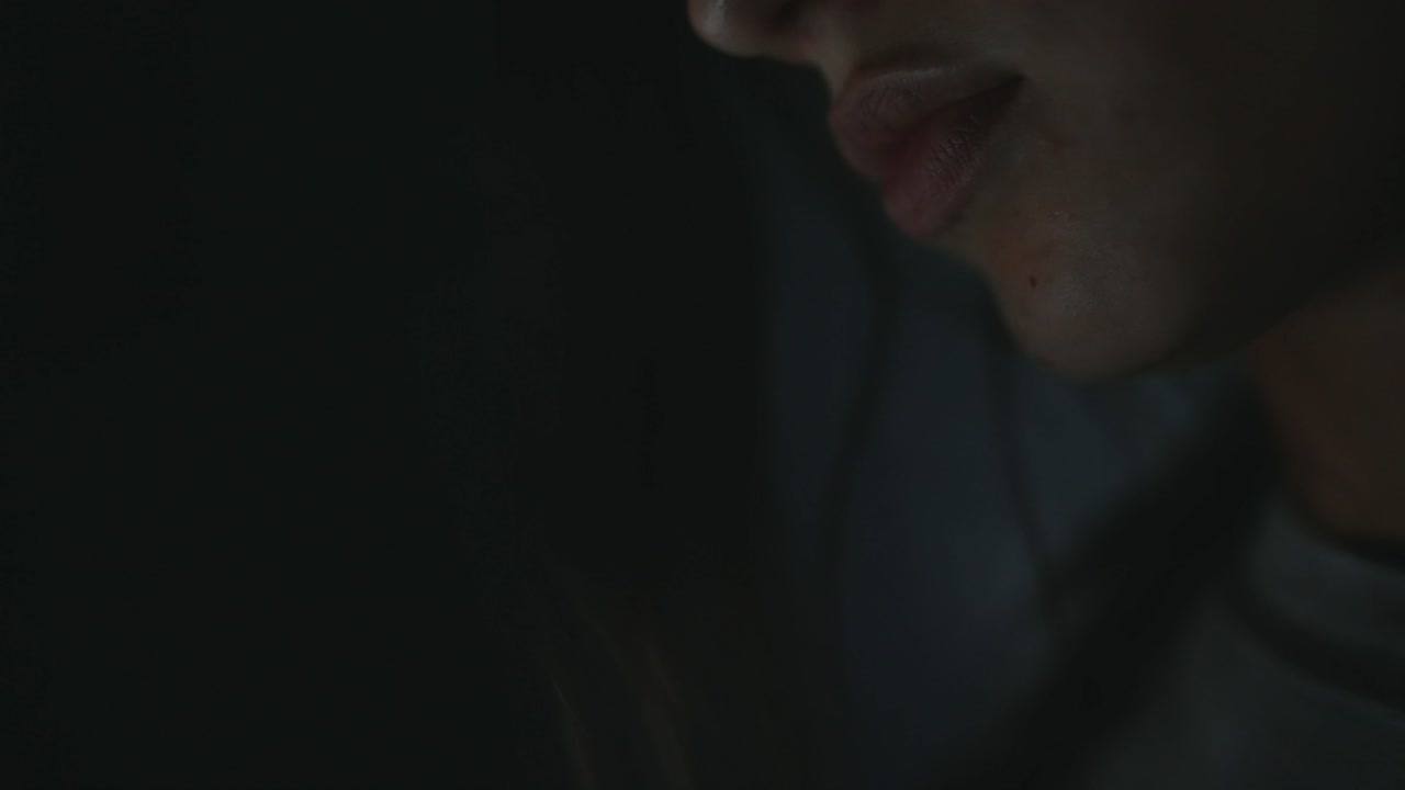 Close up of a person's face in the dark