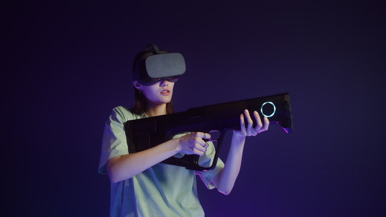 Woman using VR headset and gun in a virtual reality game