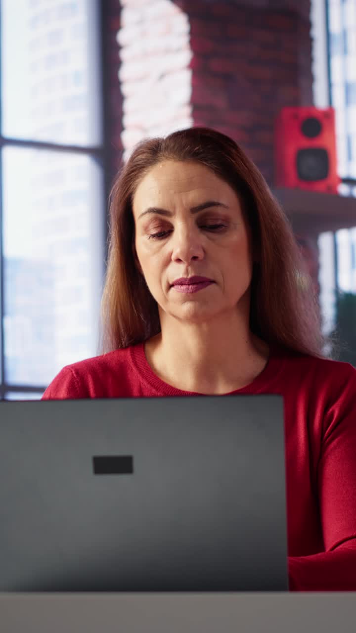 Vertical Video Confident woman solving her tasks on a freelance platform at home