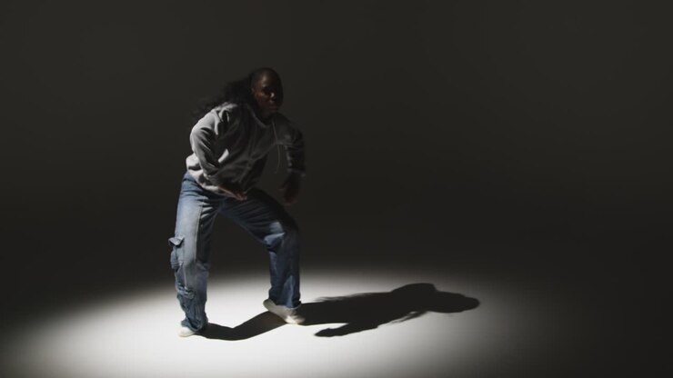 Full Length Studio Portrait Shot Of Young Woman Dancing In Spotlight 1