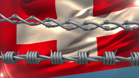 barbed wires against waving switzerland flag