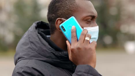 man talking on phone while wearing a mask