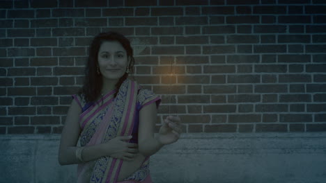 Girl-with-sparkler-celebrating-diwali-in-the-street---Slow-motion