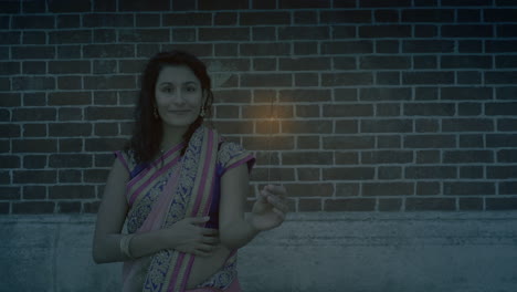 girl with sparkler celebrating diwali in the street - slow motion