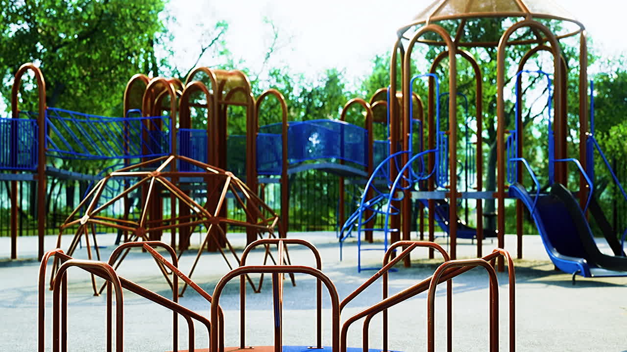 A vibrant playground filled with colorful structures stands in a sunlit park