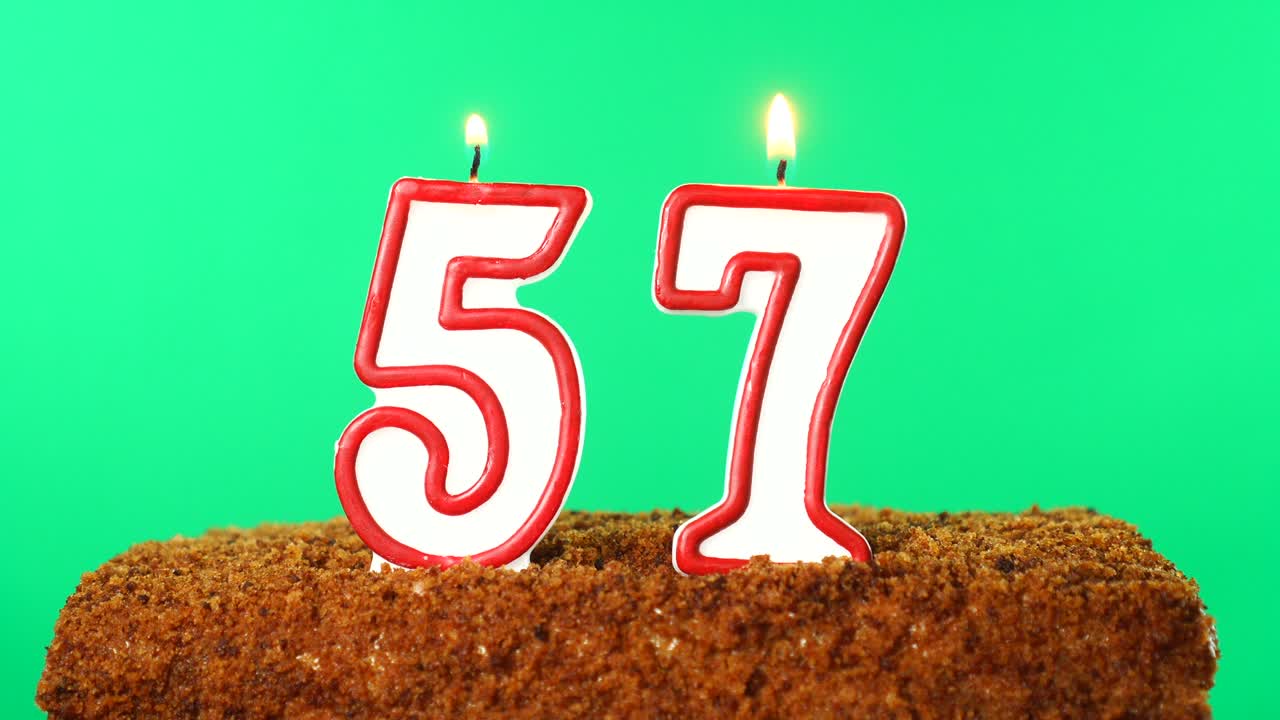 Cake with the number 57 lighted candle. Chroma key. Green Screen. Isolated