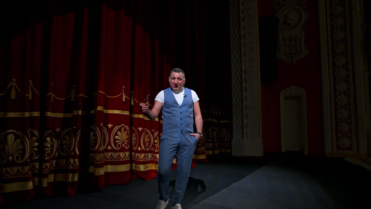 Actor performs on stage. Man on stage during performance in theater