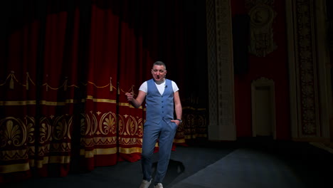 actor performs on stage. man on stage during performance in theater