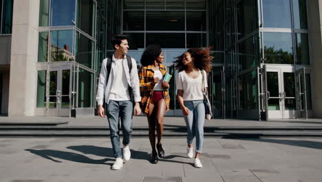 diverse group of students walking and talking on a university campus
