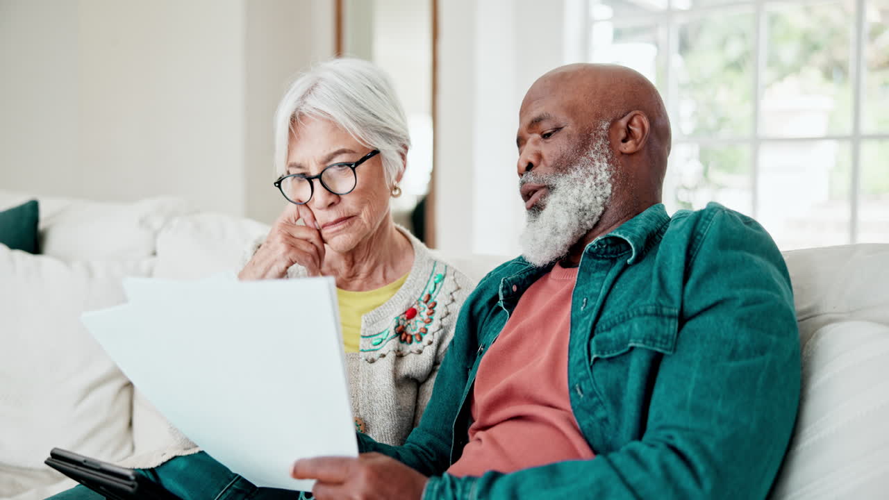Old couple on couch with finance