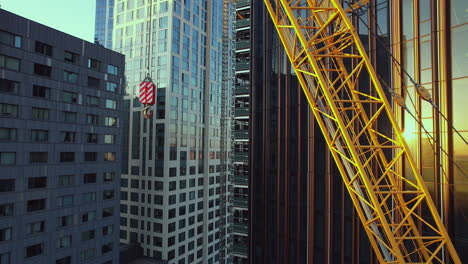 Pullback-Shot-Of-Huge-Yellow-Crane-Near-Brooklyn-Tower-Under-Construction,-NYC