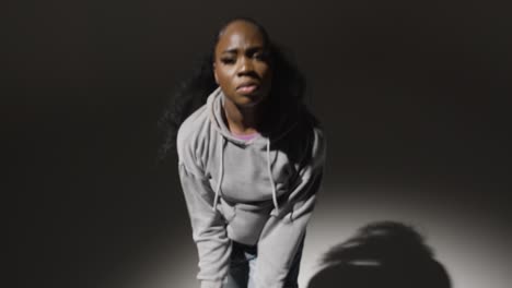 studio portrait shot of young woman dancing in spotlight in real time 1