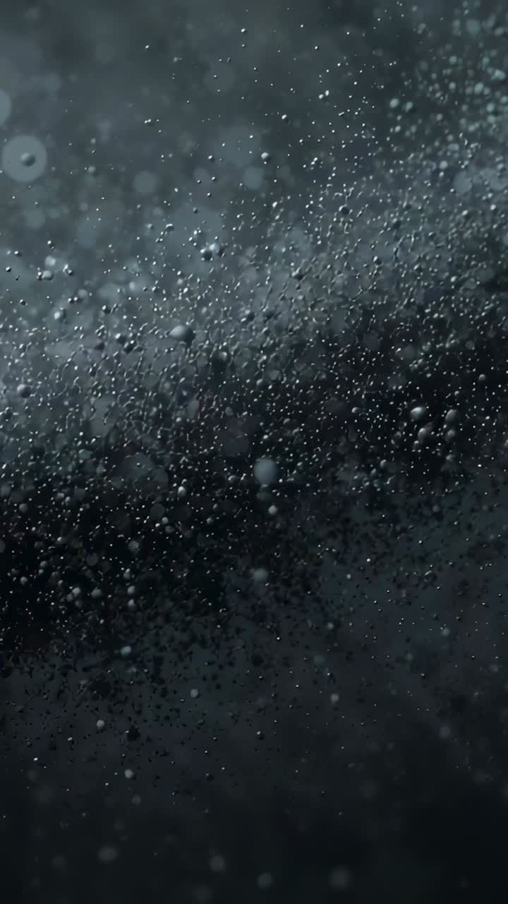 Vertical video: Recording dense water droplets becoming sharper on wet pane, with light shifting