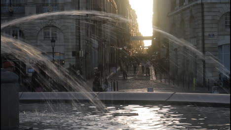 city street with fountain and people