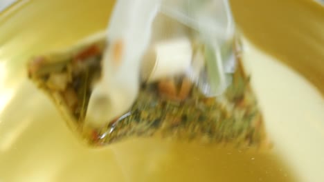 green tea and tea bag on table, close up