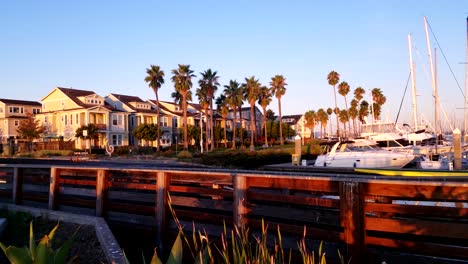sunrise over a retirement community near luxury sail boats in the marina
