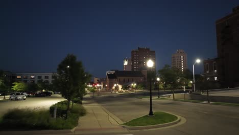 Jackson,-Michigan-downtown-at-night-with-drone-video-low-to-the-ground-moving-forward