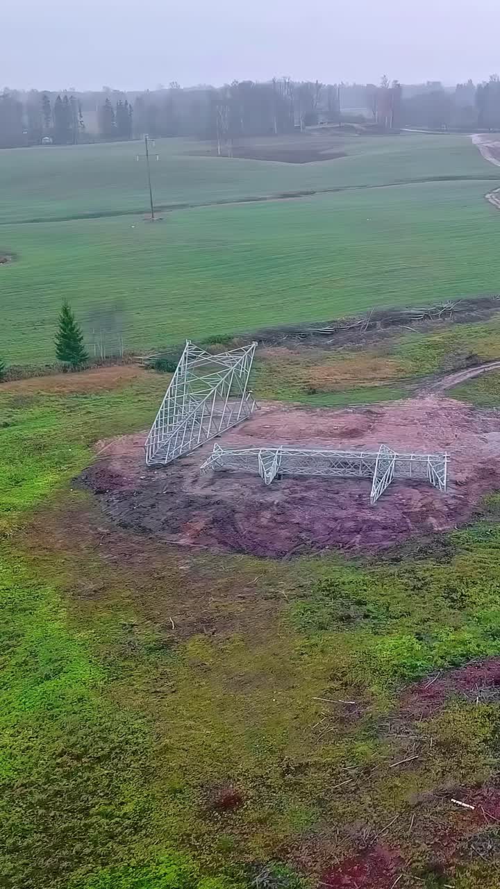 New Power Line Pylon Lying On The Ground - Vertical Shot