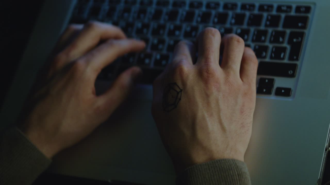 Person Typing on Laptop at Night