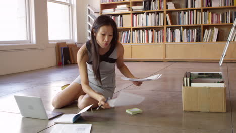 businesswoman laying out documents on floor shot on r3d