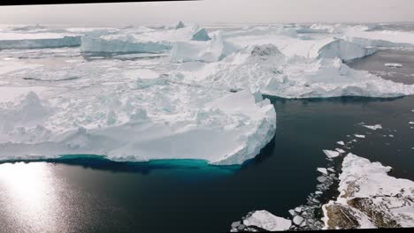 drone over sea and ice of ilulissat icefjord