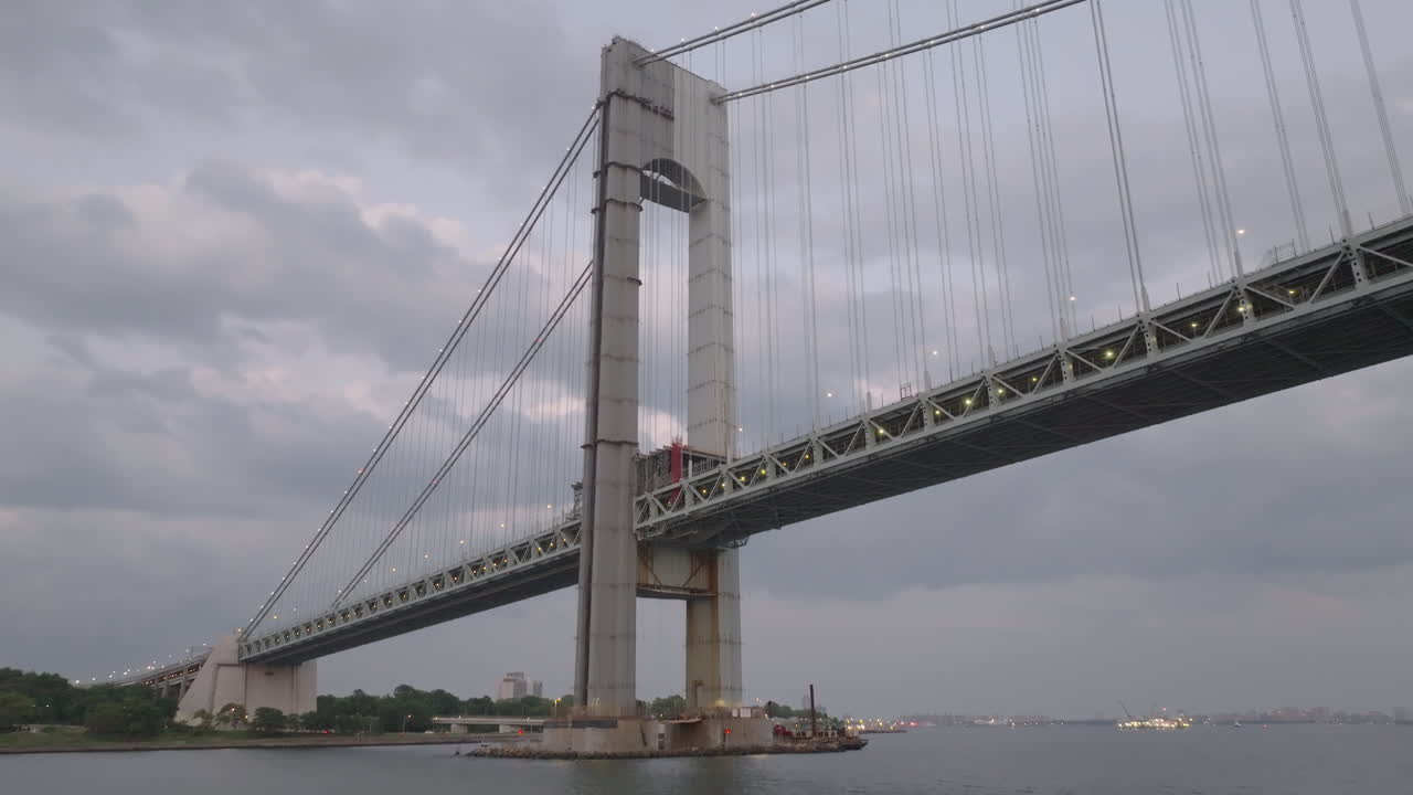 Drone shot looking up at the Verrazzano-Narrows Bridge on an overcast day. Shot in New York City