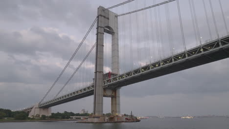 drone shot looking up at the verrazzano-narrows bridge on an overcast day. shot in new york city