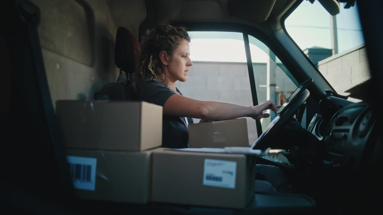 A woman preparing packages inside a delivery van