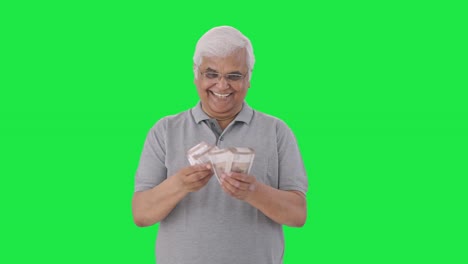 Happy-Indian-old-man-counting-money-Green-screen