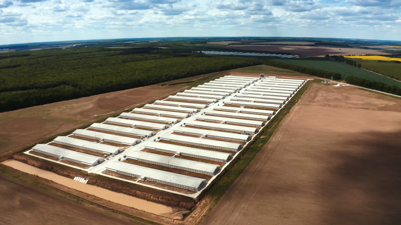 Contemporary outdoor factory in spring. Large territory of a modern industrial plant on the field on nature background. Aerial view.