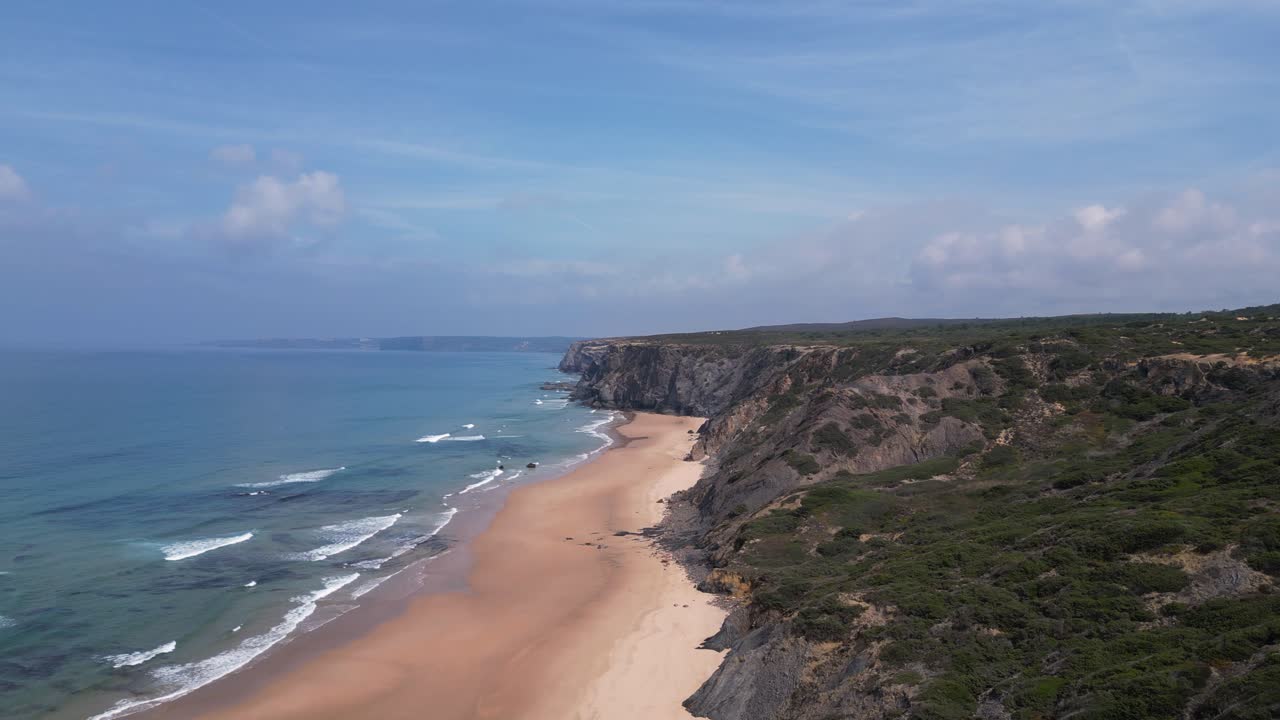 Nature background: Sea cliff, ocean, and sandy beach with copy space