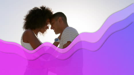 purple wavy lines against biracial couple dancing at the beach