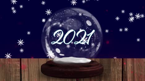 Animation-of-2021-in-snow-globe-on-wooden-boards,-shooting-star-and-snow-falling