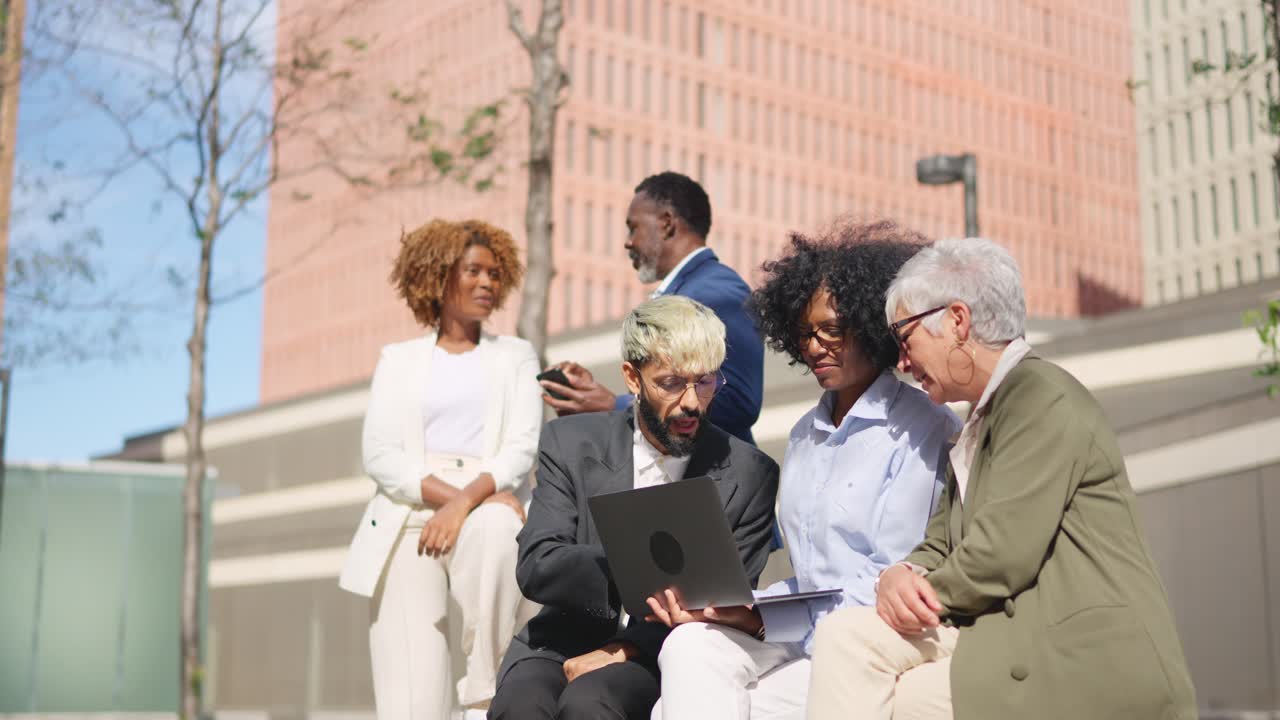 Diverse business team collaborating outdoors