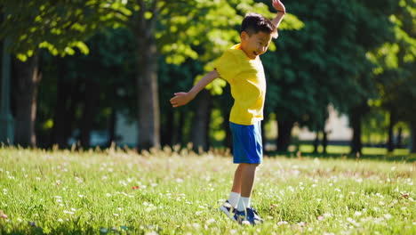 young boy running and playing in a sunny park