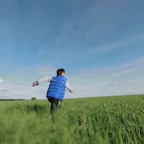 boy running down a meadow
