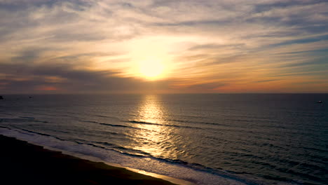 Aerial-drone-footage-of-sun-setting-over-the-Pacific-Ocean-in-Southern-Oregon