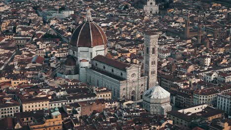 aerial high orbit left over florence duomo, italy, intricate dome and surrounding rooftops with intricate gothic tower