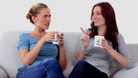 Friends-chatting-over-cups-of-coffee